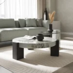 Goldoma modern round coffee table with white MDF base and clear glass top in a living room setting