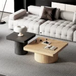 Goldoma modern nesting coffee table set in oak wood with cylindrical fluted pedestal on living room floor