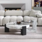 Goldoma modern round coffee table with white MDF base and clear glass top in a living room setting