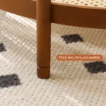 Modern farmhouse nesting coffee table set with ribbed glass tops and copper accents on a living room floor