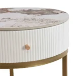 Goldoma modern nightstand with drawer featuring round marble-look sintered stone top and metal frame in a bedroom setting