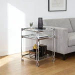 Goldoma 3-tier acrylic coffee table with tempered glass top and stainless steel frame in a modern living room setting