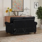 Goldoma black faux leather loveseat with memory foam cushions and wood legs in a modern living room