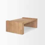 Solid wood coffee table with natural finish and sled base in a modern living room