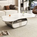 Modern butterfly coffee table with sintered stone top and storage drawer in living room