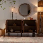 Goldoma gold sideboard buffet cabinet with solid wood arched doors and gold hardware in a modern dining room