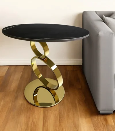 Black and gold round pedestal end table with faux marble top and gold stainless steel base in a modern living room