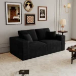 Goldoma modular loveseat sofa bed in black corduroy upholstery with iron legs, showing sofa bed conversion for small spaces