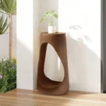 Goldoma modern outdoor side table on a patio with a hollow design