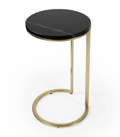 Black marble round end table with gold base in a living room setting