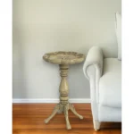 Goldoma 20-inch beige round end table with distressed rustic finish in a living room setting