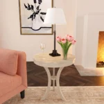 Goldoma 26 inch beige distressed round three-leg end table in a living room setting