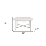 Goldoma 36-inch round coffee table with white paper veneer top and silver metal cross legs in a modern living room