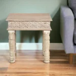 Goldoma 24 inch solid wood end table with natural distressed finish, square top, placed next to a sofa in a living room