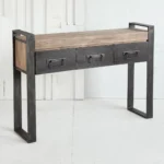 Goldoma narrow console table with drawers in solid oak and black metal sled base, placed in an entryway with decor