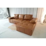 Goldoma brown faux leather cloud sectional sofa with tufted back and deep seat chaise in a modern living room