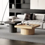Goldoma modern nesting coffee table set in oak wood with cylindrical fluted pedestal on living room floor