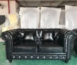 Goldoma PU Leather Chesterfield sofa set in modern living room with tufted back and aluminum legs