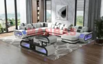 Goldoma genuine leather sectional sofa with LED lighting, storage shelves, USB ports, and cup holders in a modern living room