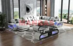 Goldoma genuine leather sectional sofa with LED lighting, storage shelves, USB ports, and cup holders in a modern living room