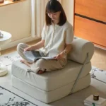 Goldoma Folding Lazy Sofa Chair in modern living room with corduroy or leather upholstery, small space