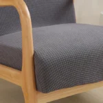 Goldoma stretch armchair slipcover with zipper in a living room, showing a snug fit on a standard armchair