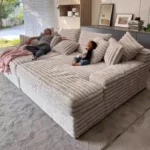 Goldoma white L-shaped velvet sofa in living room with wood frame and removable covers