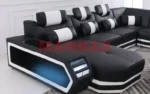 Goldoma genuine leather sectional sofa with LED lighting, storage shelves, USB ports, and cup holders in a modern living room