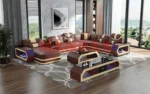 Goldoma genuine leather sectional sofa with LED lighting, storage shelves, USB ports, and cup holders in a modern living room