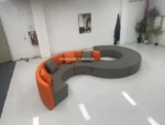 Goldoma modern S-shape PU leather modular sectional sofa set in an office lobby