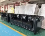 Goldoma PU Leather Chesterfield sofa set in modern living room with tufted back and aluminum legs