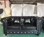 Goldoma PU Leather Chesterfield sofa set in modern living room with tufted back and aluminum legs