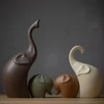 Close-up of a matte gray ceramic elephant figurine with textured surface and subtle sheen.