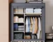 Freestanding clothes rack with hanging rod and 5 shelves in a bedroom