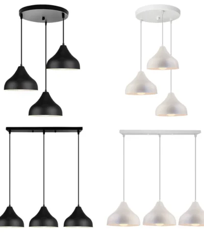 Nordic minimalist iron pendant lamp shade with 3 heads in matte black, hanging above a wooden dining table.