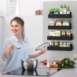 Black magnetic spice rack attached to refrigerator side, holding spice jars neatly organized