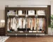 Portable closet organizer with 4 hanging areas and 4 storage zones in a small bedroom