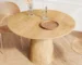 Solid wood dining table in natural oak finish, round 43 inch, placed in a modern dining room with chairs