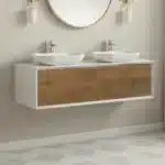 Open cabinet doors revealing interior storage space, with a white sink and marble top above.
