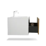 The vanity against a tiled wall, showcasing its sleek design and chrome handle hardware.