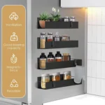 Black magnetic spice rack attached to refrigerator side, holding spice jars neatly organized