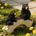 Close-up of the resin bear figurine showing textured fur and a black bear cub clinging to the mother bear's back.