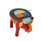 Handcrafted mango wood elephant ottoman stool with hand-painted Rajasthani folk art used as a bohemian side table in living room