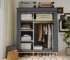 Goldoma portable wardrobe closet with 6 storage areas in a bedroom setting