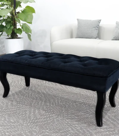 Mid-century velvet ottoman with wood legs in black - Goldoma