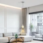 Goldoma Jellyfish pendant light with acrylic shade glowing warmly in a minimalist living room