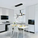 Modern LED pendant light hanging in a living room, casting warm light on a sofa