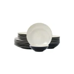 Elegant dinnerware set with white minimalist plates arranged on a wooden table