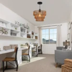 Rustic cage hanging lamp in a farmhouse living room, complementing neutral decor and wooden furniture.