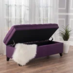Purple fabric storage ottoman with hidden compartment and birch wood legs in a living room